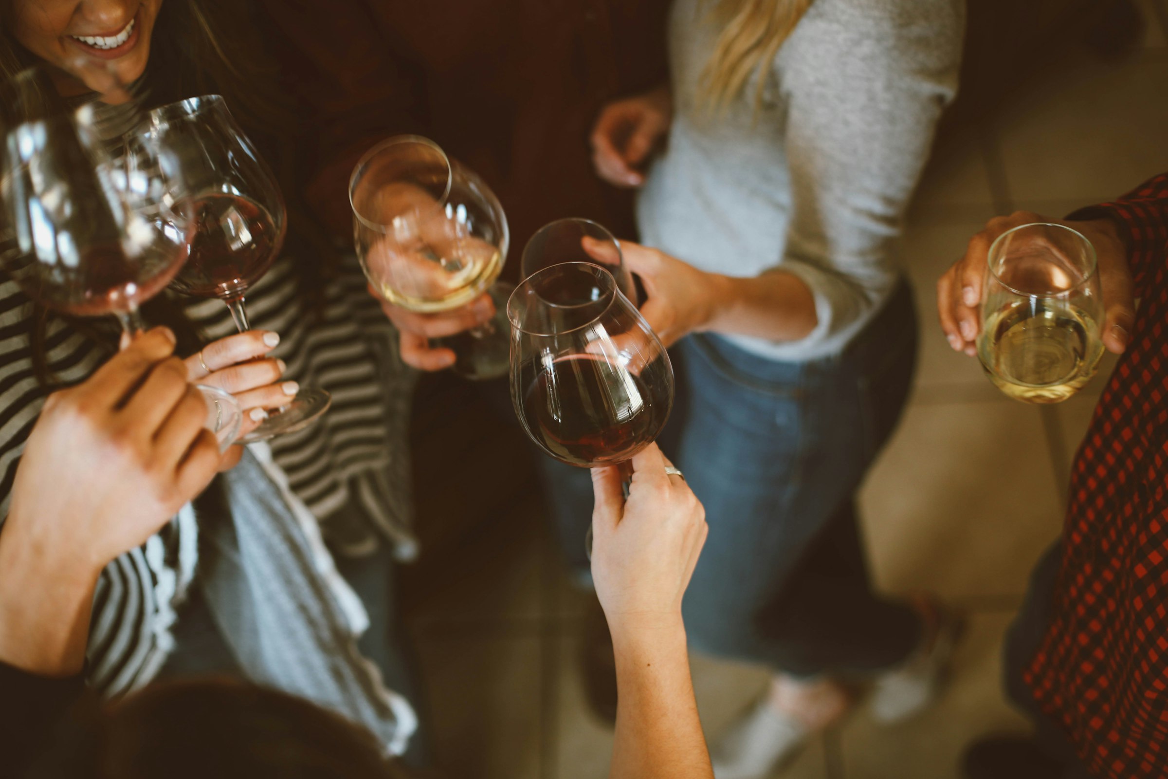 Guests raising their glasses together at an evening celebration
